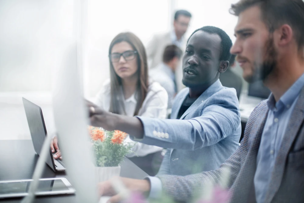 About ValidateLabs - photo of people in around a screen